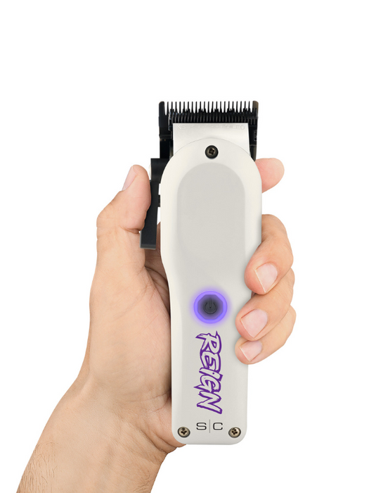 Hair trimmer held in a hand with a white background