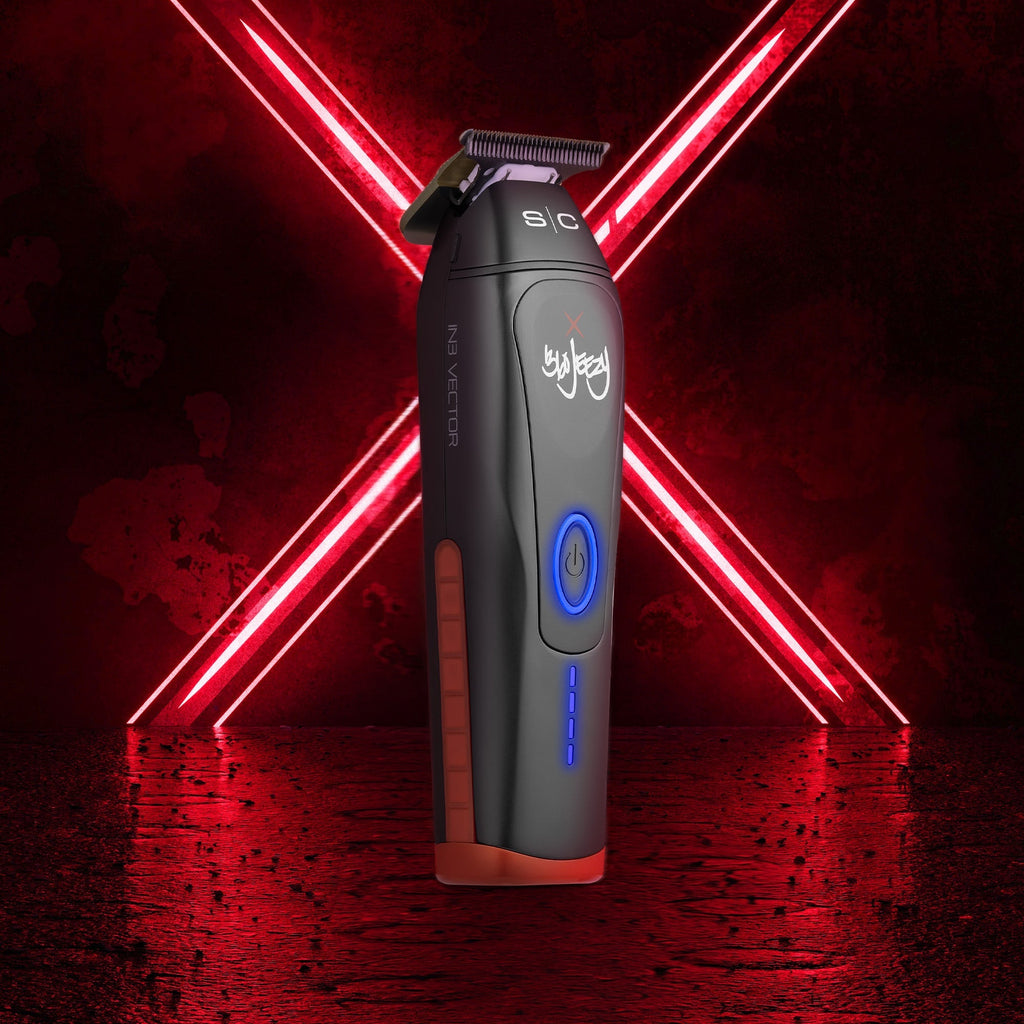 Black cordless hair trimmer with blue lights, held at slight angle, gold blade